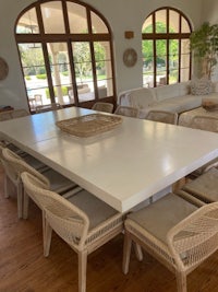 a white dining table and chairs in a living room